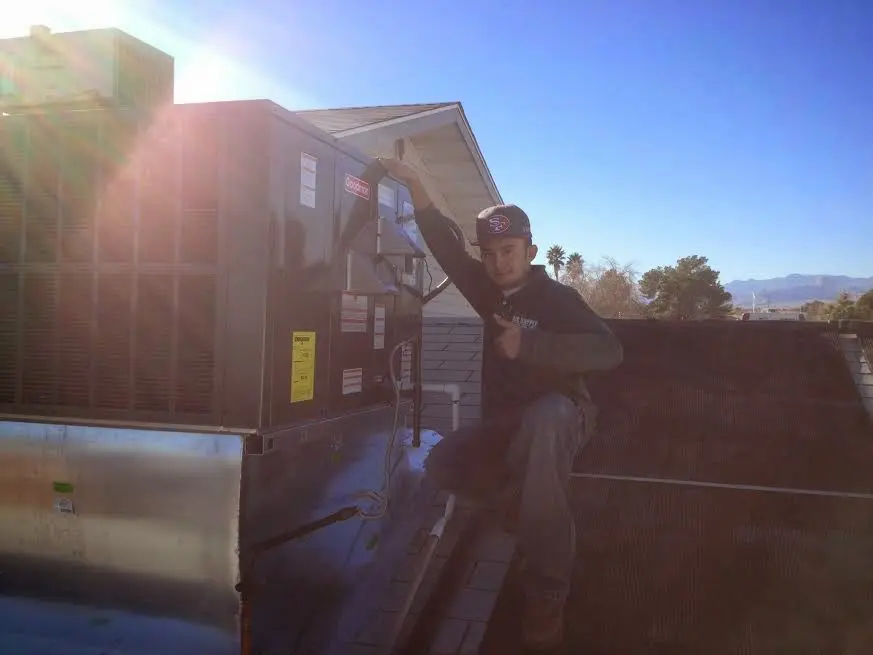 HVAC technician performing HVAC Inspection on a rooftop unit in Thermalito